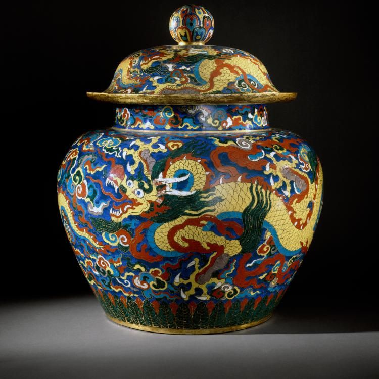 Red and blue jar with lid and yellow dragon open mouthed travelling across.