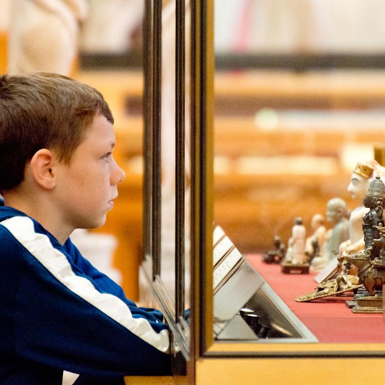 A young visitor looking at the display objects