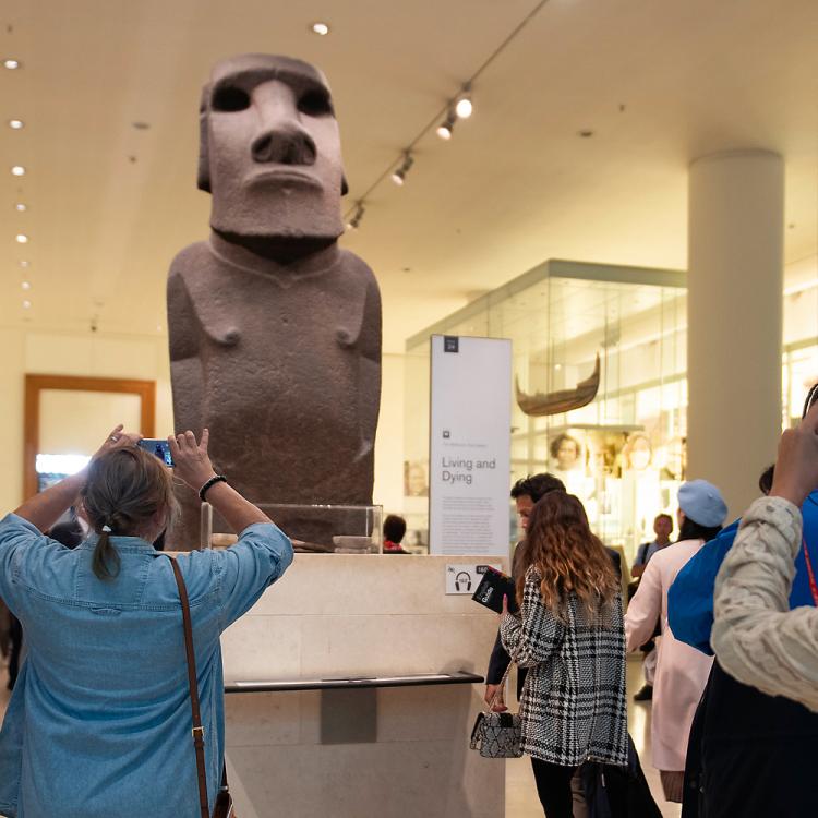 Visitors photographing the sacred statue of Easter Island Hoa Hakananai'a. 