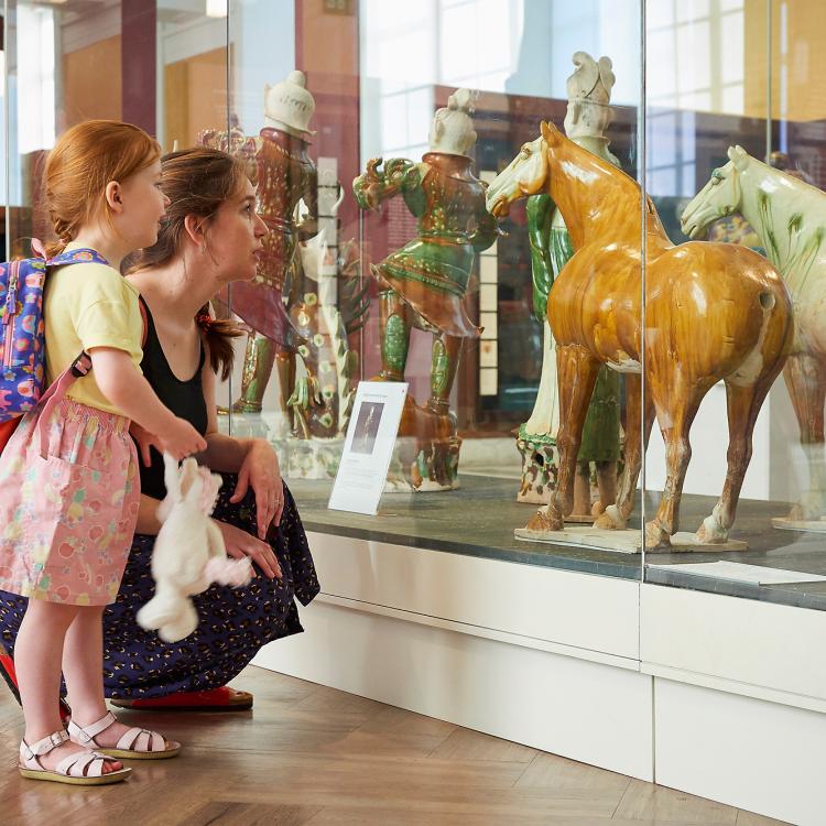 A mother and daughter looking at objects in room 33