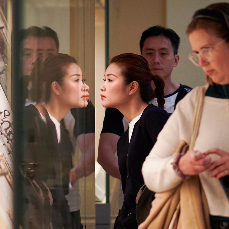 Visitors in room 49 looking into the display cases