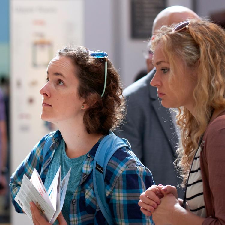 Visitors looking at one of the Christian wall paintings