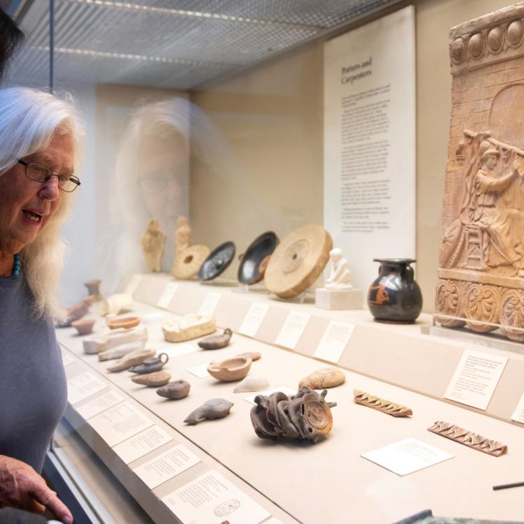 Two female visitors looking at the objects on display in Room 69