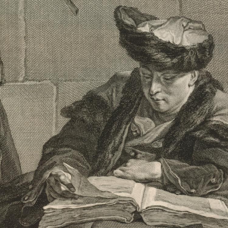 Man wearing fur-trimmed coat and hat, sitting at a table and reading a book