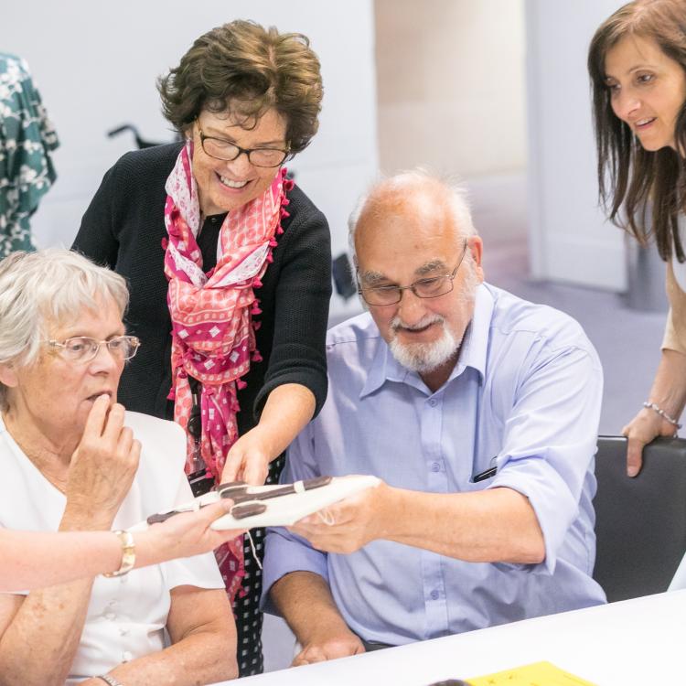 Five member of the Age Friendly Museums Network engaging in a object holding session.