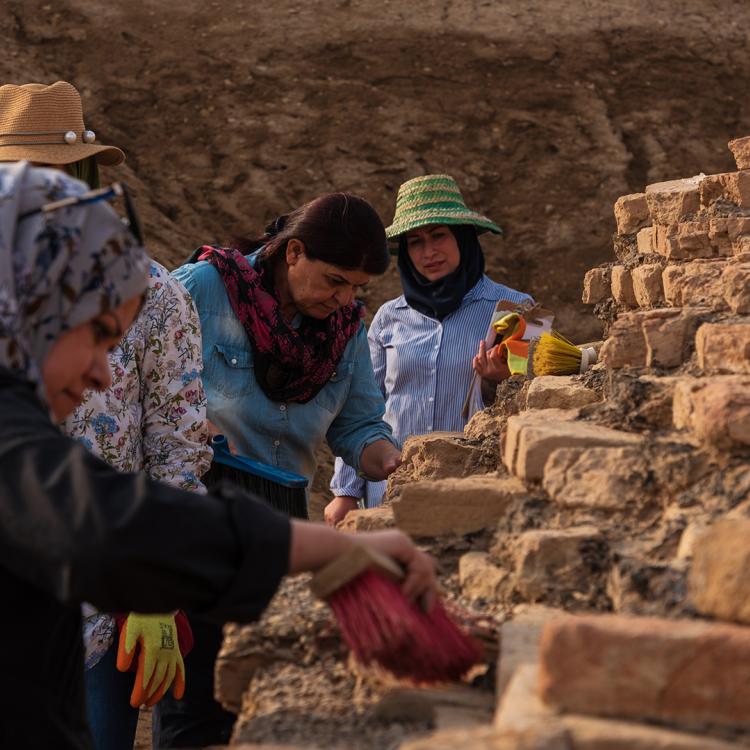 Group of archaeologists dusting bricks at the Bridge of Girsu.