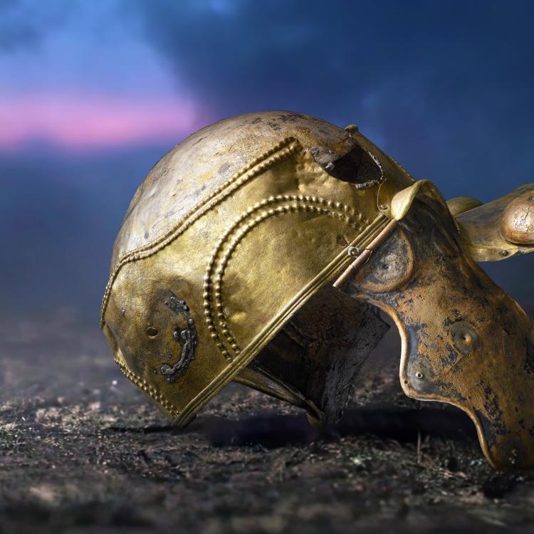 Bronze helmet lying on the earth.