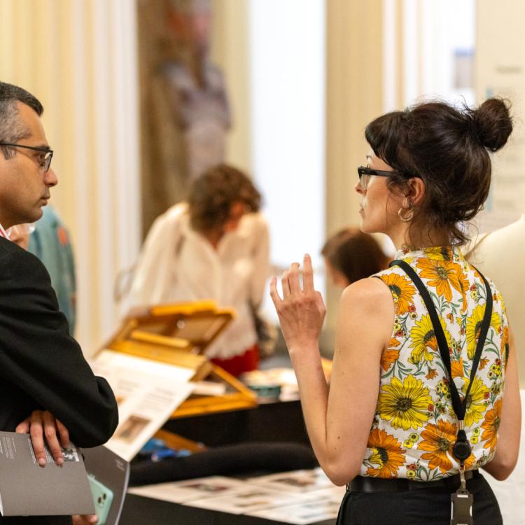 A member talking to British Museum staff during an exclusive Members' event