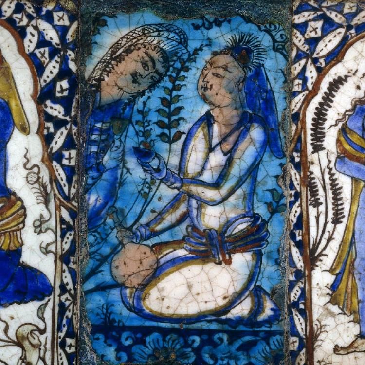 Panel of three tiles painted in white blue and brown with figures in a variety of poses, including a woman carrying a baby.