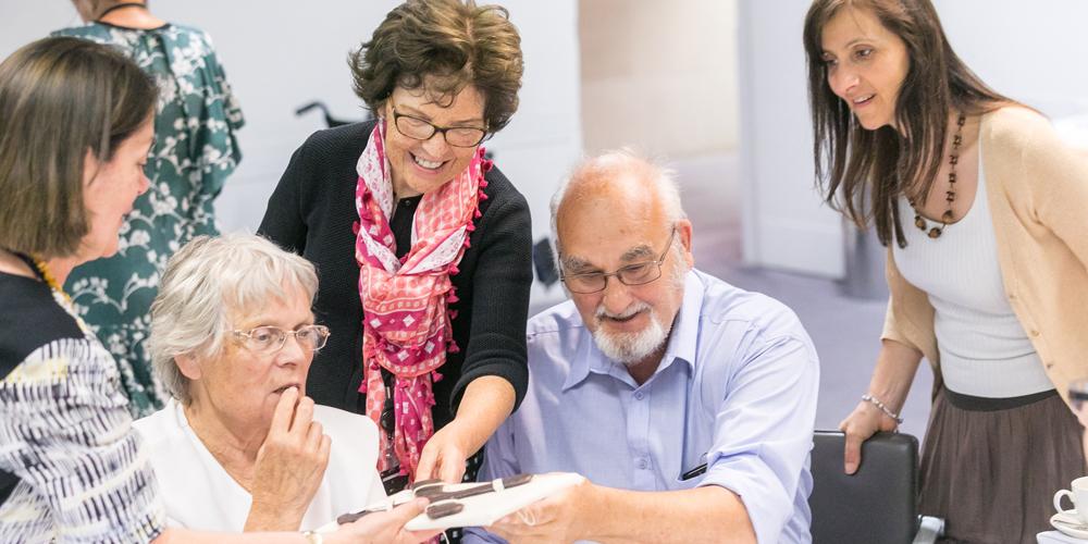 A group of visitors to the British Museum explore objects as part of a facilitated session