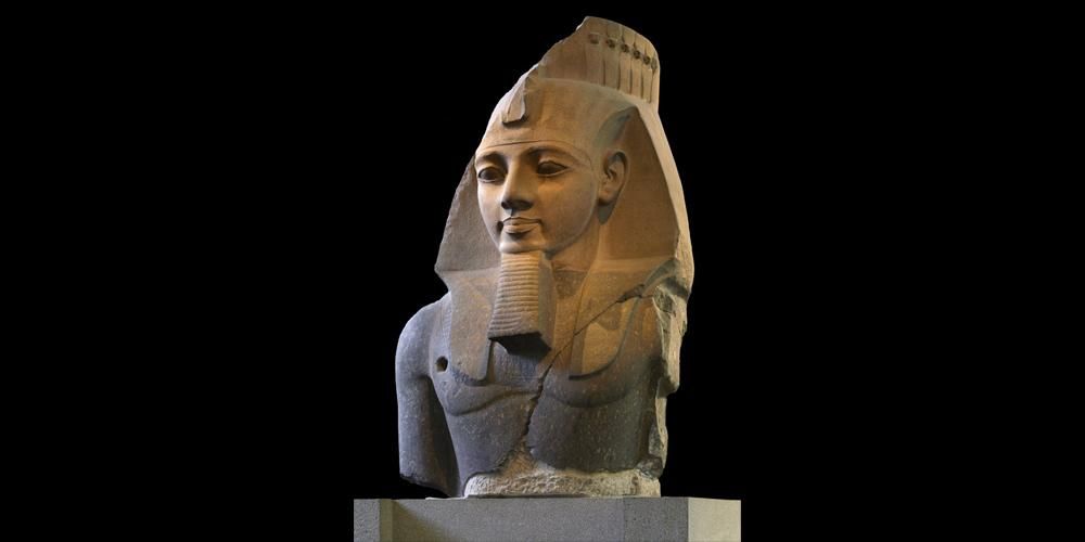 The Younger Memnon, 19th Dynasty, head and upper body of pink/grey granite monumental statue of Ramses II