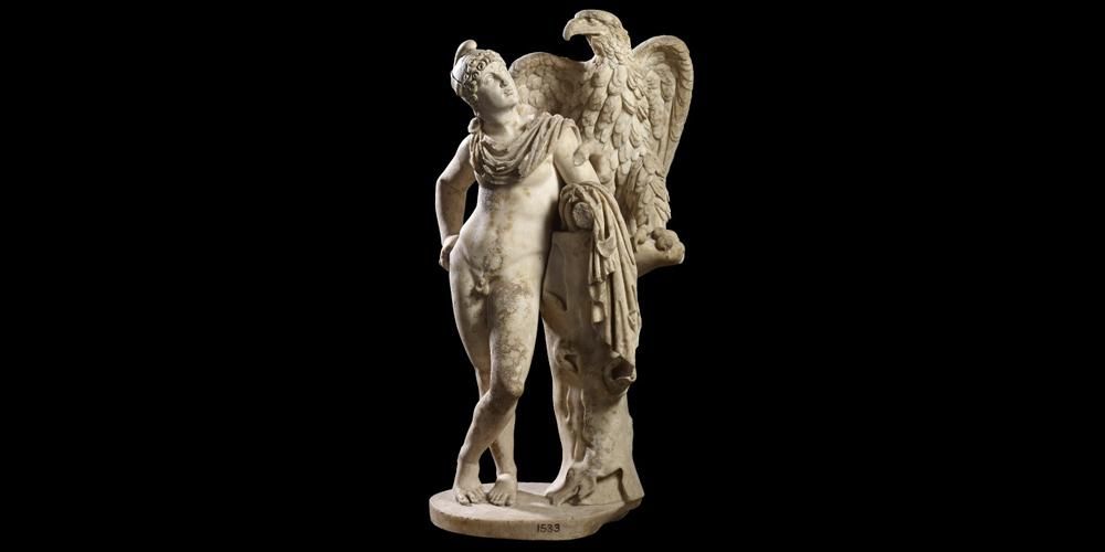 Marble sculpture of Ganymede and the eagle; Ganymede with phrygian cap and chalmys; leans on stump of tree and looks to the eagle which stands on it