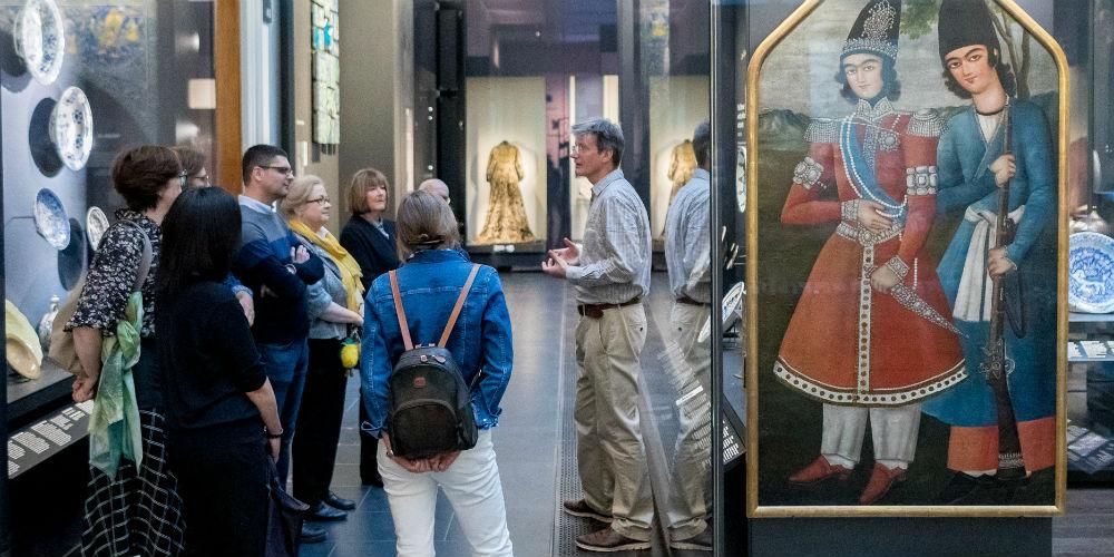 Volunteer giving Islamic World tour to group of Museum visitors