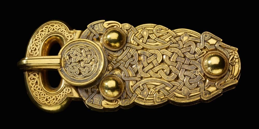 A finely detailed and symmetrical gold belt buckle.