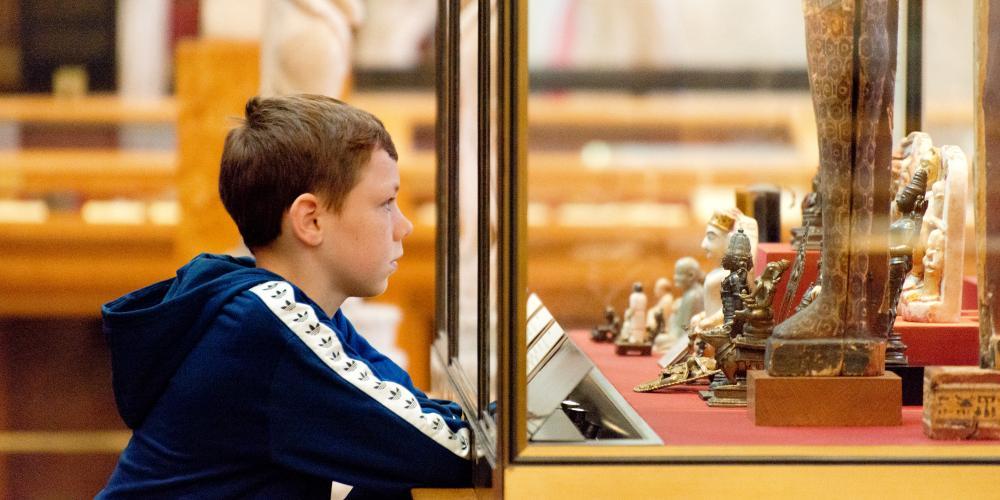 Young visitor viewing the displays in the Enlightenment gallery. 