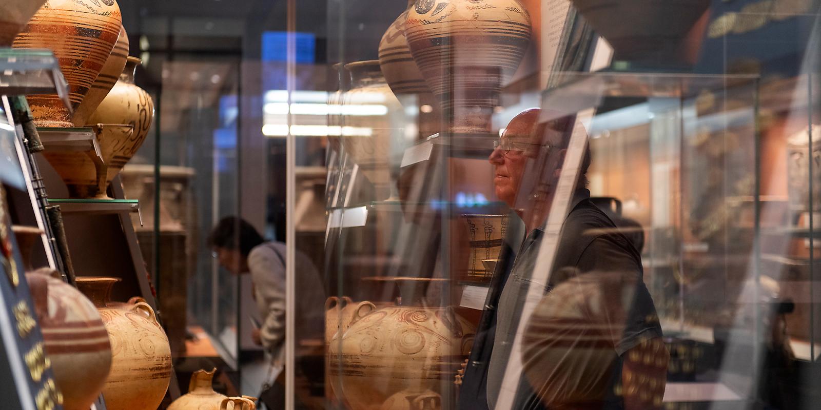 A visitor looking at pieces from the Bronze Age made in Crete.