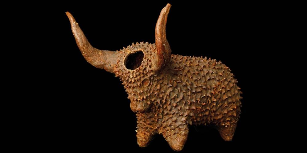 Spiked ox with large horns, container hole through forehead. 