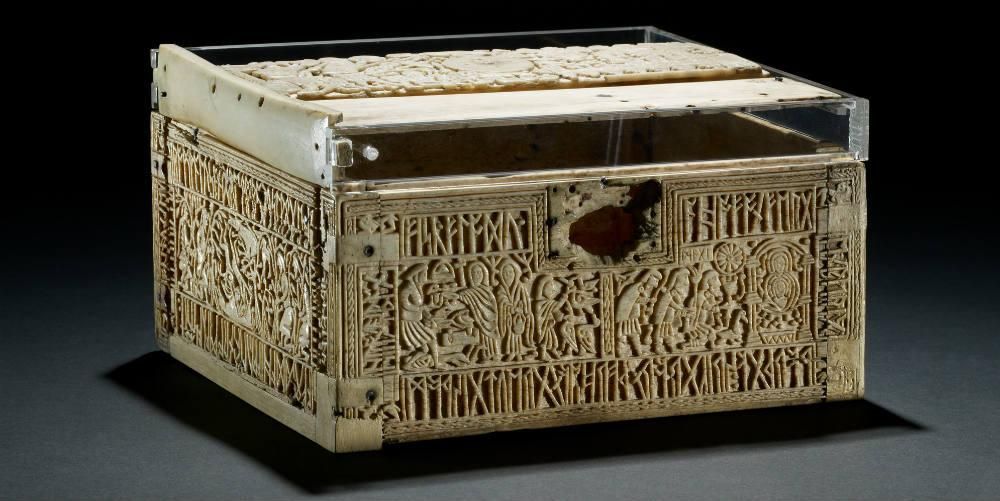 A rectangle casket box made from whale-bone with carved illustrations of religious scenes upon it. 