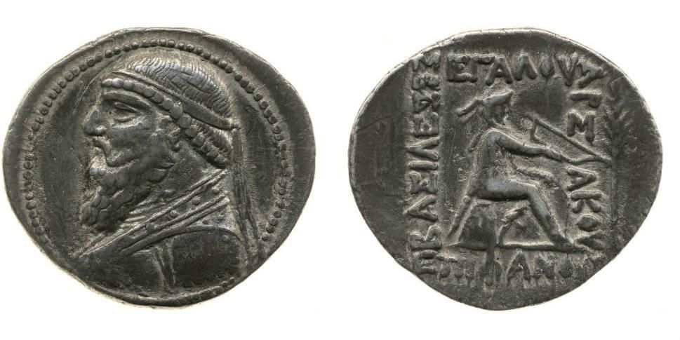 Silver coin showing bearded Mithradates II on one side and archer seated on omphalos. 