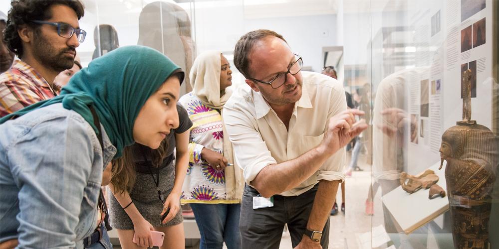 British Museum staff member taking visitors on a tour. 