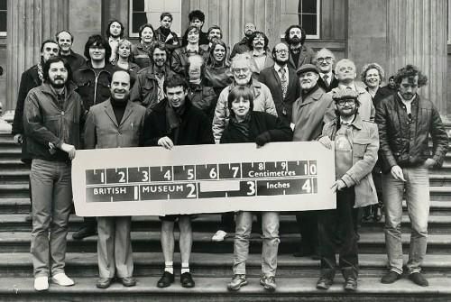 Black and white photograph showing the in-house photography stood on the steps outside the British Museum. 