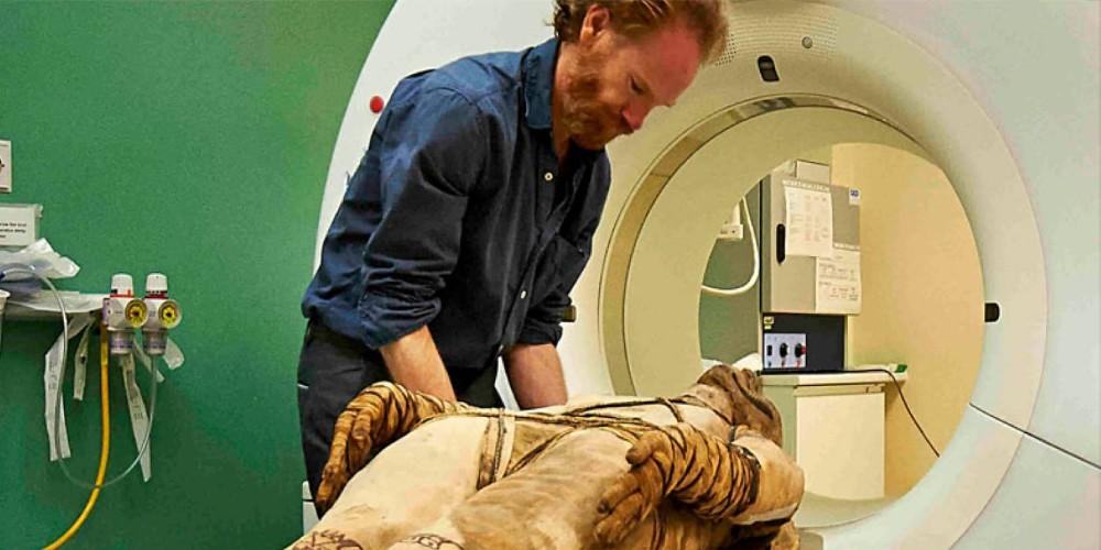 A mummy, researcher and CT scanner