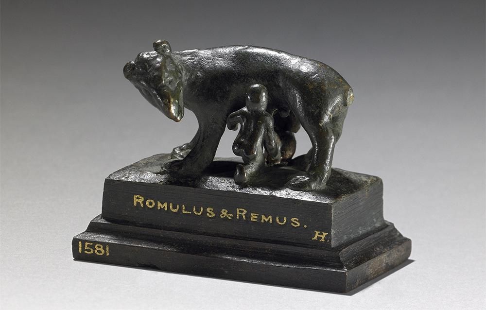 Bronze figure of Romulus and Remus with the she-wolf who is said to have nutured them, mounted on a rectangular base.