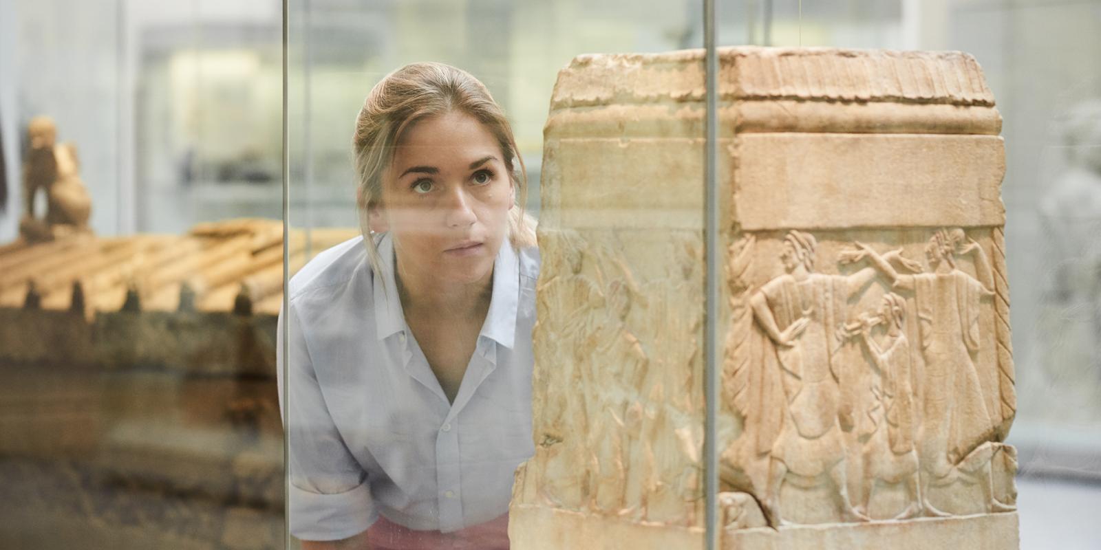 Female visitor looking at a statue in Room 71.