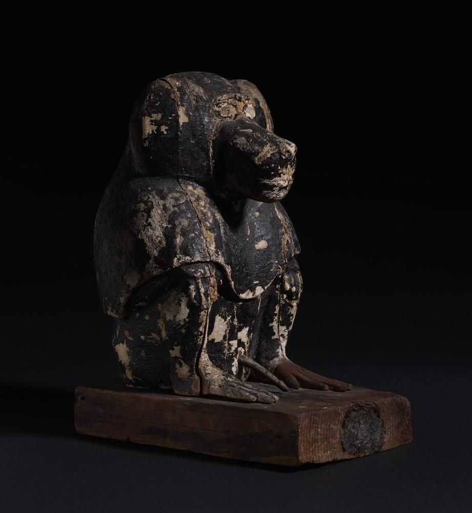 Wooden crouched baboon on a rectangular base