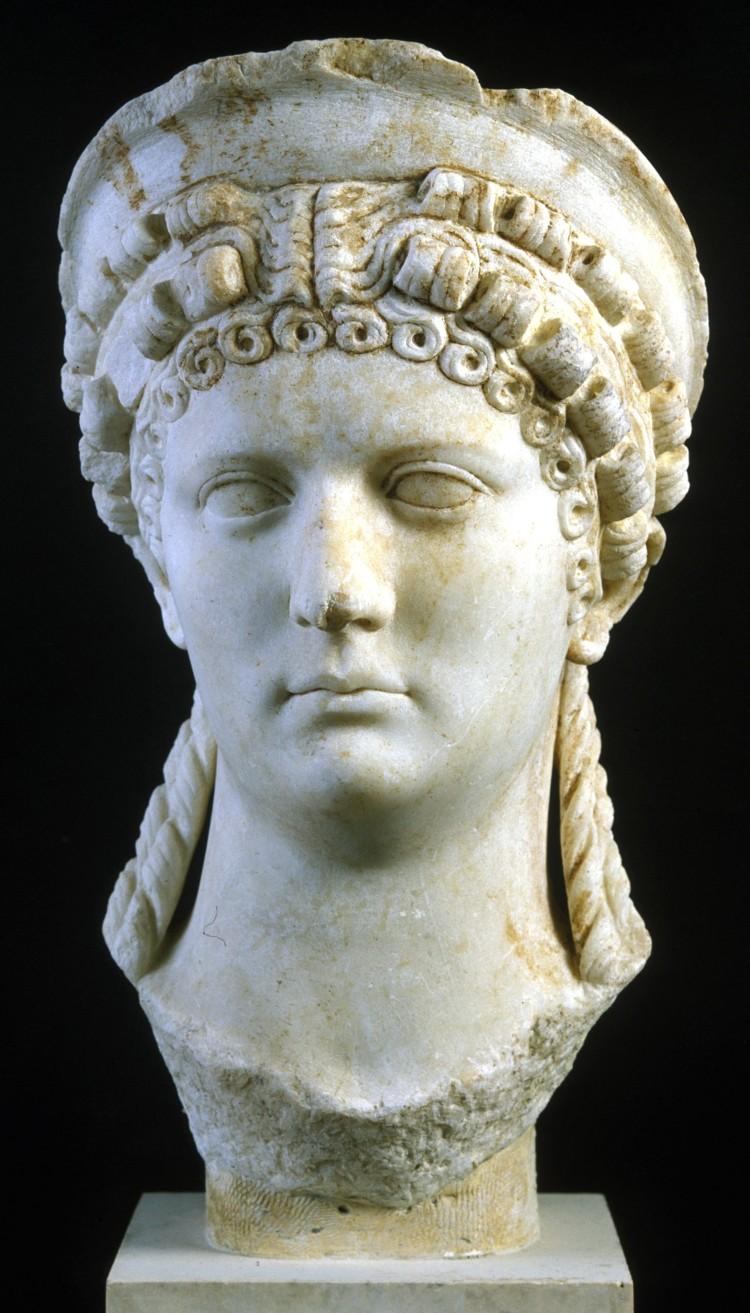 Marble sculpture of head of woman with long hair and headress