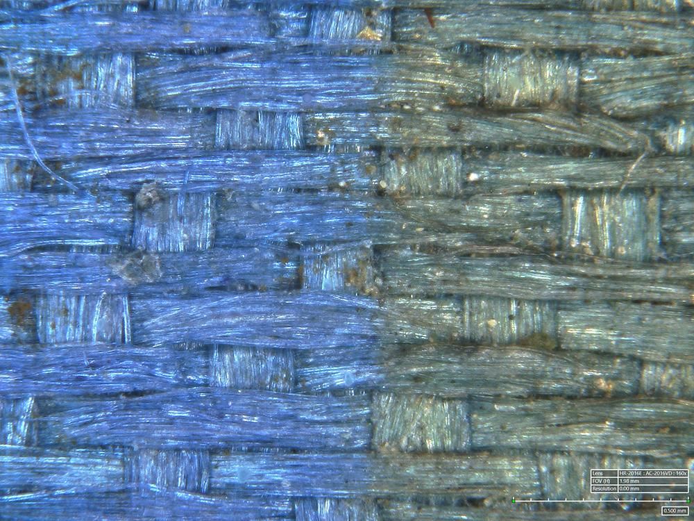 Close up of weaved textile, one half is an indigo blue and the other a grey-blue.