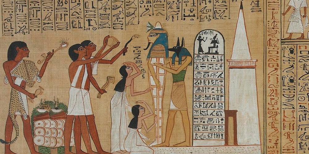 A photograph showing the Book of the Dead papyrus with a funeral scene in ancient Egypt. The deceased, Hunefer, is shown as a mummy, stood outside his tomb embraced by a priest dressed as jackal-headed Anubis, god of the dead. Other people standfacing mummy, mourning, giving offerings and saying spel