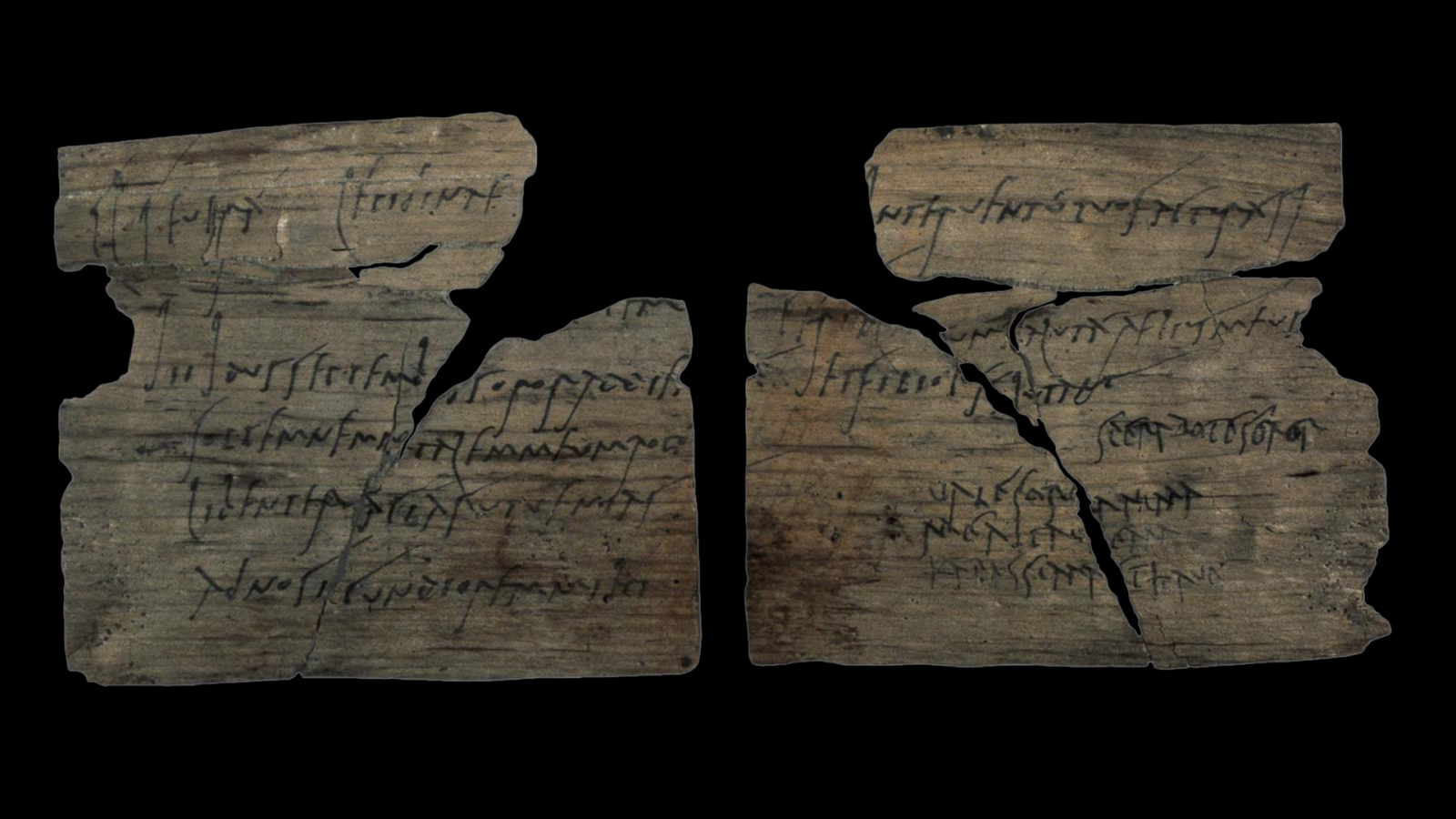 A wooden writing tablet fragment with handwriting in ink