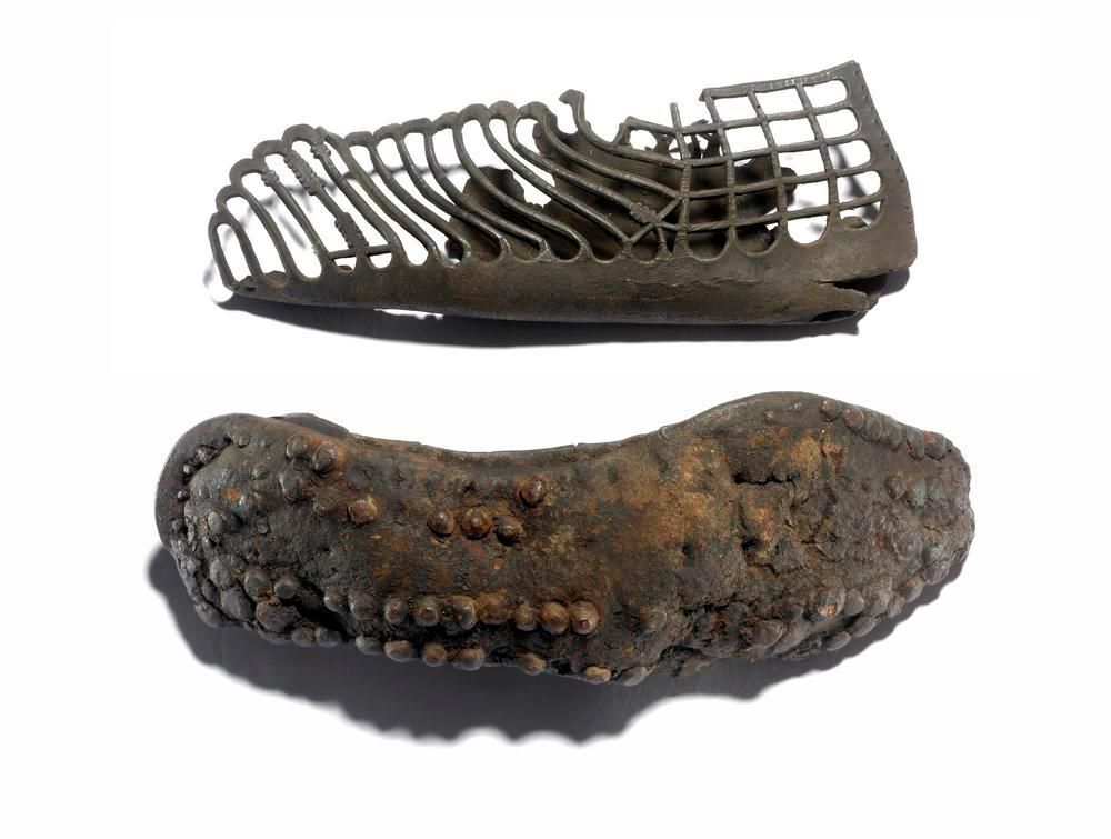 The remains of a leather sandal, showing leather straps and a sole with studded grips