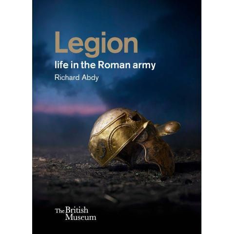 A book cover with a bronze helmet in the dirt and a dramatic night sky behind with the words Legion life in the Roman army on it and the British Museum logo